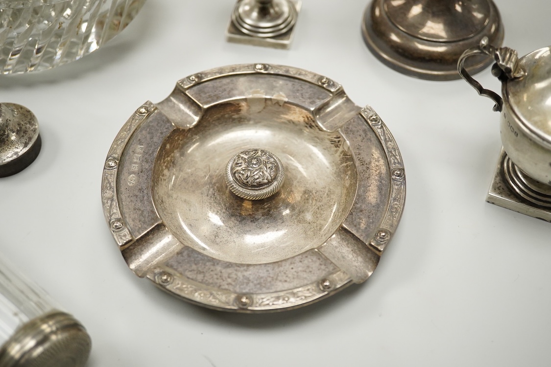 An Elizabeth II silver mounted vase with wavy border, Adie Brothers, Birmingham, 1955, weighted, 20.4cm, a silver mounted glass swan bonbon dish, a George V silver three piece condiment set, a silver mounted glass toilet